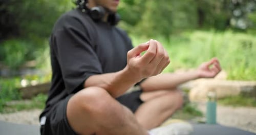Hands Closeup Young African American Spirituality Man Meditating Yoga Asana Sitting in a Park