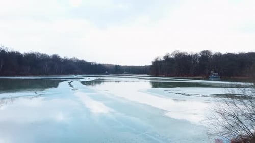 Aerial: Verchat pond and Cabanes des Grands Reflets during the day in Joncherey, France