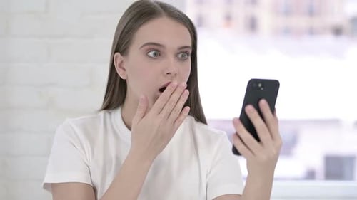 Woman Reacts with Surprise to Smartphone Content