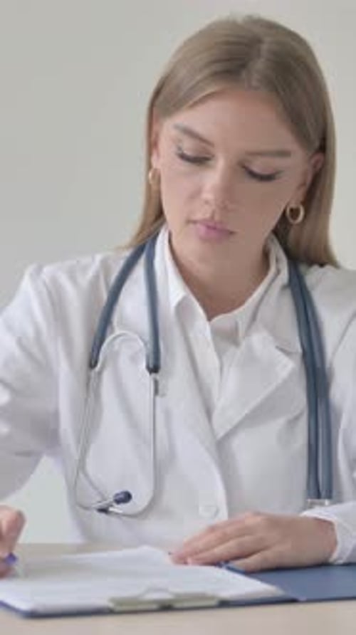 Close Up of Female Doctor Writing Medical report, Vertical Video