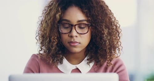 4k video footage of an attractive young businesswoman working on her laptop in the office