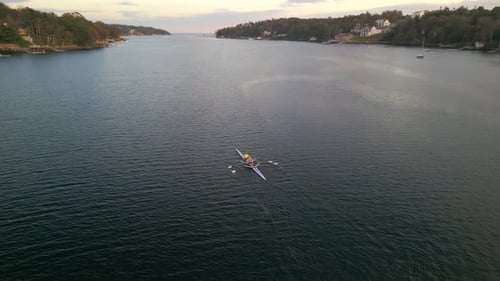 Aerial View of Sport Rowing Canoe Boat Being Driven By Two Young Women in Ocean