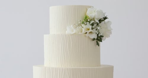 Three Tiered Wedding Cake with White Floral Arrangement