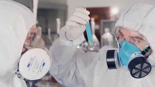 Scientists Examining Test Tube in Lab Coats