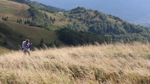 Girl Hiker Walking By The Grassy Mountain Hill