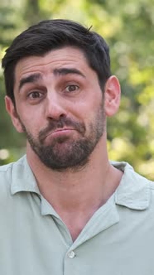 Happy Man in Shrugging Shoulders at City Park During Sunny Day