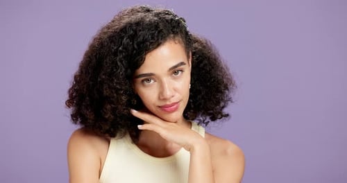Face, skincare and woman in studio for glow, beauty and dermatology on purple background space