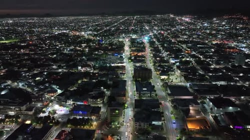 aerial drone tour at night in a city full of lights and cars at high speed in 4k