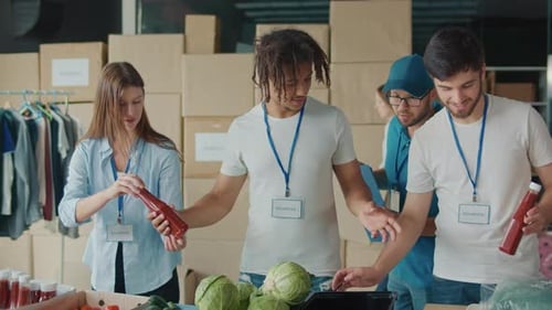 Volunteers Sorting Food Donations at Charity Warehouse