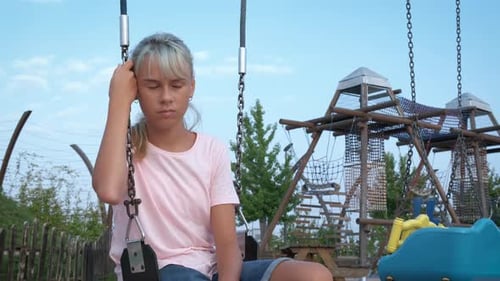 Lonely Teen in Abandoned Swing