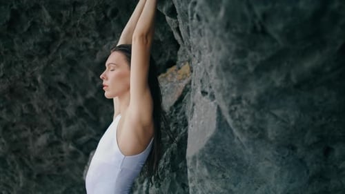Calm Beautiful Girl Leaning on Coast Rock Wearing White Sexy Swimsuit Close