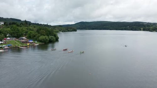 wide follow drone shot of race rowing boats on dam in brno city