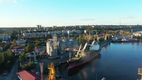 Aerial of Wheat Loading to Bulker Ship Cargo Hold at Sea Grain Elevator in Sea Port Wheat Shipment