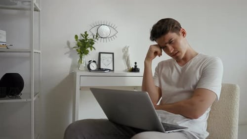 Man Feels Tired Listening to Online Lecture Via Laptop