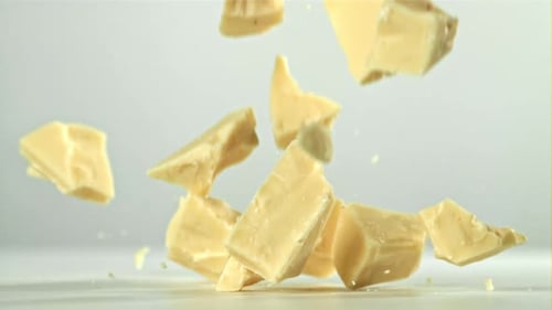 Pieces of White Chocolate Fall on the Table Filmed on a Highspeed Camera at 1000 Fps
