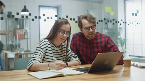 Young Casual Business Couple are Using Laptop in Creative Agency Loft. Friendly Easygoing Coworking