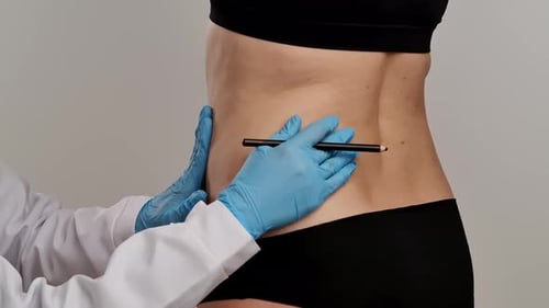 Healthcare Professional Examining Patient is Flank Area