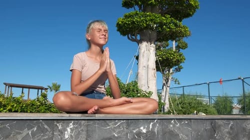 Young Person Practicing Yoga Outdoors in Peaceful Setting