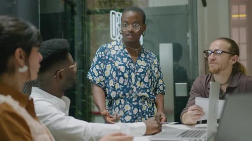 Female Team Leader Talking to Colleagues on Office Meeting