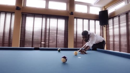 Man Hitting The Number 12 Pool Ball