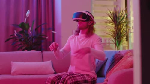 Young Adult Using VR Headset in Cozy Home Setting