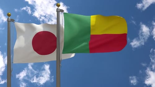 Waving Flags of Japan and Benin Against a Blue Sky