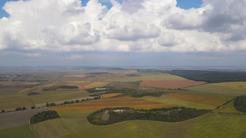Aerial View of Panoramic Landscape and Clouds Over the Horizon Drone Flies Forwards