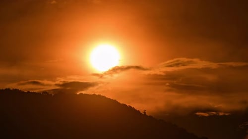 Dramatic Golden Sunrise over Mountain Ridge with Clouds