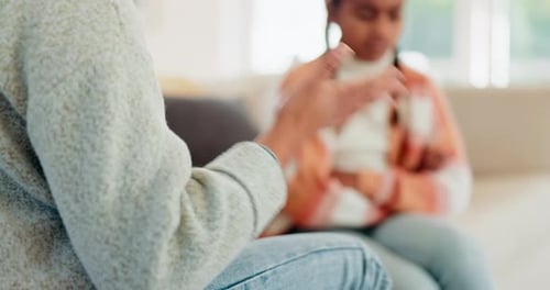 Adult Talking with Young Girl on Couch