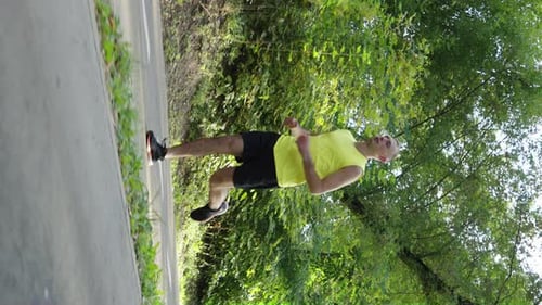 Vertical Screen Sportsman Running on Road in Slow Motion
