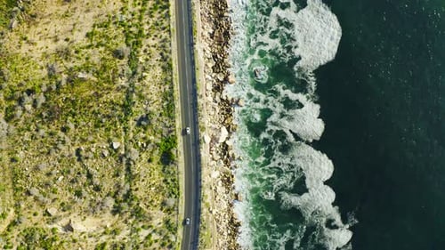 4k video footage of a busy road in between Cape Town's terrain and the ocean which surrounds it