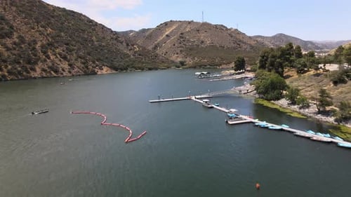 Flying on a drone, the view of the boats in motion in a lake in California Freeway 5.
