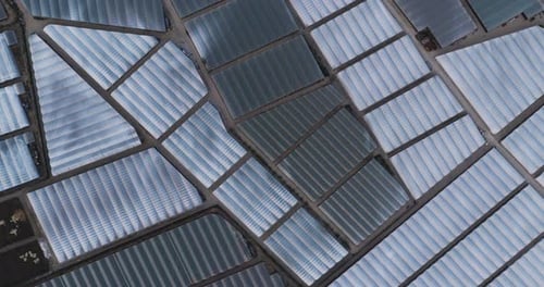 Aerial view of geometric greenhouse patterns, Italy.