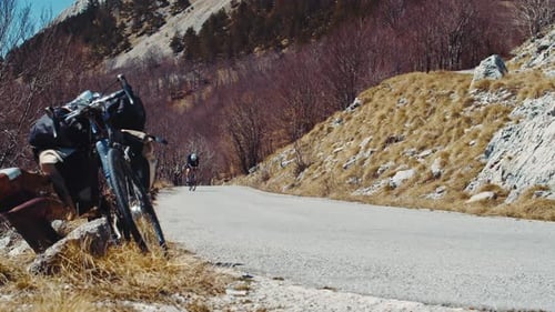 Sportsman cycling on road outdoors in beautiful countryside landscape