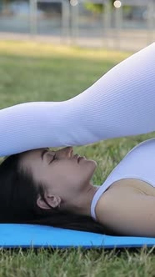 Woman Exercising Outdoors on a Yoga Mat