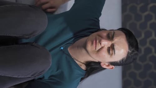 Sad Woman Hugging Knees on Couch