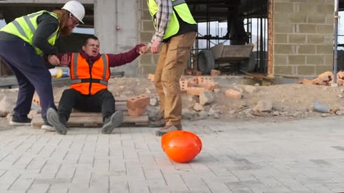 Workers trying take to hospital injured colleague after an accident at construction site.