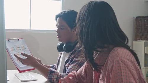 Asian Students Discussing On School Project