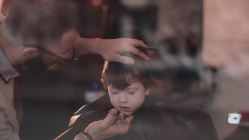 Boy Getting a Haircut at Barbershop