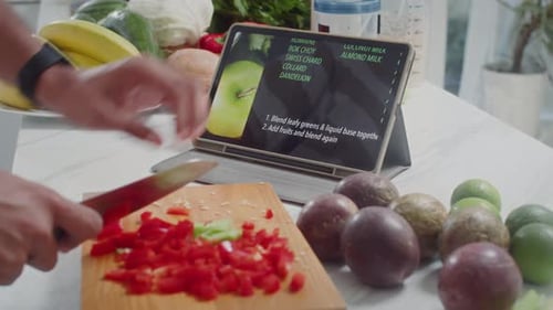 Preparing Smoothie Ingredients Following Recipe on Tablet
