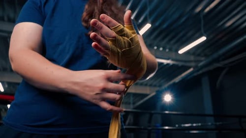 Woman Wrapping Hands with Boxing Wraps
