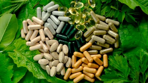 Dietary Supplements on Fresh Green Leaves