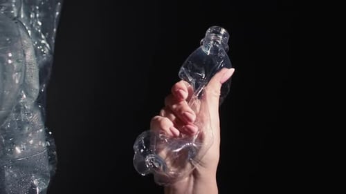 Hand Crushing Empty Plastic Bottle for Recycling