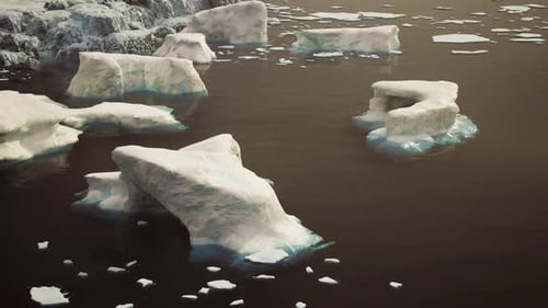 Scattered Ice Fragments Viewed From Above Over Cold Dark Sea