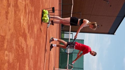 Woman and Man Practicing Tennis on Sunny Day