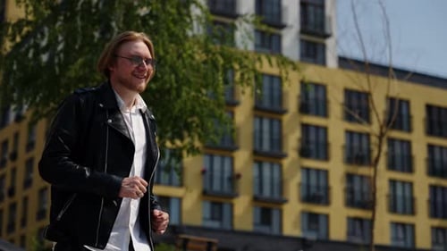 Closeup Shot of a Man Coming Down the Stairs Hurry to Work Summer Mood Black Leather Jacket Blonde