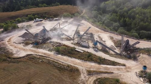 Aerial view of stone jaw crusher plant. Sand making plant and belt conveyor in mining quarry