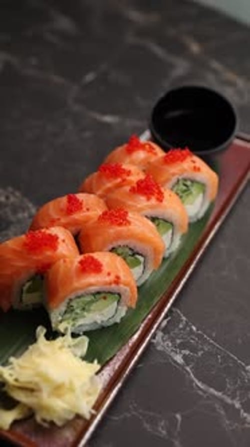 Close-up of delicious Japanese sushi rolls served fresh on a plate in a restaurant.