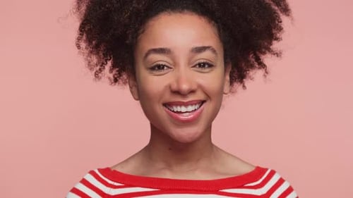 Smiling Woman Winking at the Camera in Studio
