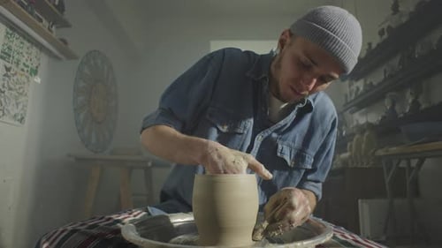 The Potter Adds Unique Lines to the Blank on the Potter's Wheel